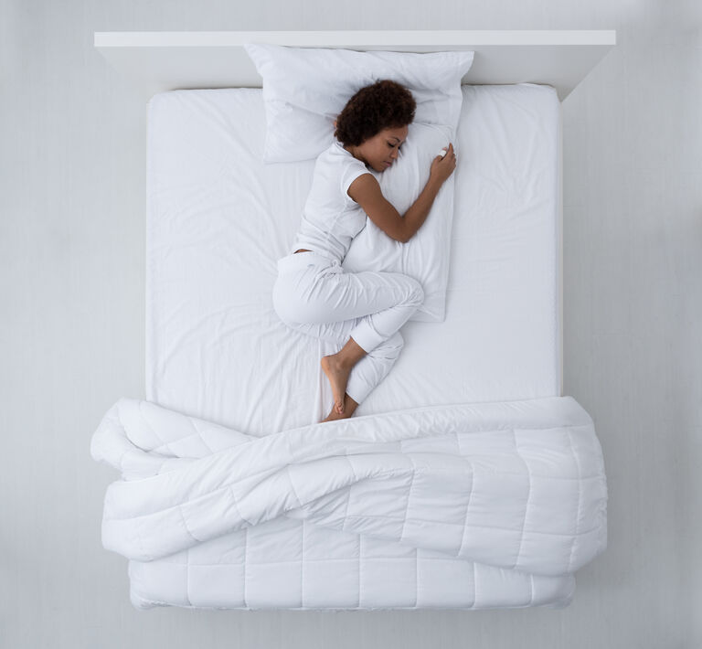 woman sleeping on white sheet